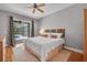 A well-lit bedroom with a sliding glass door leading to a screened patio and pool at 15309 Palomapark Ln, Lithia, FL 33547