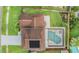Overhead view of home with solar panels and a pool, surrounded by green landscaping at 15609 Gardenside Ln, Tampa, FL 33624