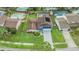 Aerial view of a landscaped home with pool and solar panels on the roof at 15609 Gardenside Ln, Tampa, FL 33624