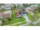 An aerial view of a beautiful home with a fenced-in pool and lush landscaping at 15609 Gardenside Ln, Tampa, FL 33624