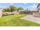 Large backyard with a stone outdoor bar, screened-in pool area, and privacy fence at 15609 Gardenside Ln, Tampa, FL 33624