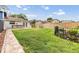 Spacious backyard featuring lush green grass, a stone outdoor bar, and a privacy fence at 15609 Gardenside Ln, Tampa, FL 33624
