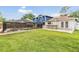 Expansive backyard featuring a pool, spa, outdoor bar, and lush lawn for outdoor enjoyment at 15609 Gardenside Ln, Tampa, FL 33624
