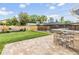Large backyard with a stone outdoor bar, screened-in pool area, and privacy fence at 15609 Gardenside Ln, Tampa, FL 33624
