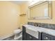Stylish bathroom with a modern vanity, farmhouse sink, marble counters and gray tiling at 15609 Gardenside Ln, Tampa, FL 33624