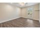 Neutral bedroom featuring hardwood floors and plantation shutters at 15609 Gardenside Ln, Tampa, FL 33624