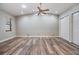 Large bedroom with high ceilings, hardwood floors, ceiling fan, and natural light at 15609 Gardenside Ln, Tampa, FL 33624