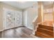 Welcoming entryway with hardwood floors, staircase, and decorative glass doors at 15609 Gardenside Ln, Tampa, FL 33624
