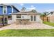 Backyard featuring a stone outdoor bar and access to the screened-in pool and patio at 15609 Gardenside Ln, Tampa, FL 33624