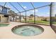 Enjoy this screened-in pool area with a bubbling hot tub and outdoor bar for entertaining at 15609 Gardenside Ln, Tampa, FL 33624