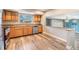 Open kitchen with granite countertops, stainless dishwasher, and breakfast bar pass-through at 15609 Gardenside Ln, Tampa, FL 33624