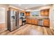 Well-equipped kitchen features stainless steel appliances, granite counters, and wood cabinets at 15609 Gardenside Ln, Tampa, FL 33624
