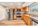 Updated kitchen with stainless appliances, granite countertops, and oak cabinetry at 15609 Gardenside Ln, Tampa, FL 33624
