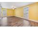 Bright living room features hardwood floors, plantation shutters, and a ceiling fan at 15609 Gardenside Ln, Tampa, FL 33624