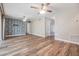 Living area with statement wallpaper, light wood floors, and access to multiple rooms at 15609 Gardenside Ln, Tampa, FL 33624