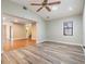 Bright living room showcasing wood-look flooring, vaulted ceiling, and connecting spaces at 15609 Gardenside Ln, Tampa, FL 33624
