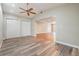 Open-concept living room featuring vaulted ceilings, wood-look floors, and neutral paint scheme at 15609 Gardenside Ln, Tampa, FL 33624