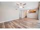Open living room with wood-look floors conveniently located close to the kitchen and hallway at 15609 Gardenside Ln, Tampa, FL 33624