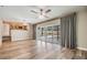 Bright, open living room featuring wood floors and sliding doors to the screened-in pool area at 15609 Gardenside Ln, Tampa, FL 33624