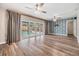 Spacious living room with sliding glass doors to pool and statement wallpaper feature wall at 15609 Gardenside Ln, Tampa, FL 33624