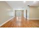Spacious living room featuring hardwood floors and natural light from sliding glass doors at 15609 Gardenside Ln, Tampa, FL 33624