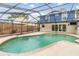 Backyard pool and spa with screened-in enclosure at 15609 Gardenside Ln, Tampa, FL 33624