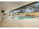 Relaxing screened-in pool and spa with ample deck space surrounded by lush landscaping at 15609 Gardenside Ln, Tampa, FL 33624