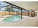 Inviting screened-in pool and spa area with a spacious deck, perfect for outdoor enjoyment at 15609 Gardenside Ln, Tampa, FL 33624