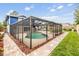 Relax by the screened-in pool with brick pavers and outdoor space at 15609 Gardenside Ln, Tampa, FL 33624