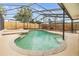 Lush backyard with a luxurious pool and spa area enclosed for privacy and enjoyment at 15609 Gardenside Ln, Tampa, FL 33624