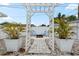 The backyard features a charming pergola and a seating area, perfect for outdoor entertaining at 1579 Palmetto St, Clearwater, FL 33755