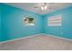 This light-filled bedroom includes durable light-toned floors, a window, and built-in shelves at 1579 Palmetto St, Clearwater, FL 33755