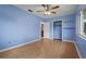 Bright bedroom with hardwood floors, a ceiling fan, a window and a closet for ample storage at 1579 Palmetto St, Clearwater, FL 33755