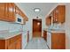 Efficient kitchen with wood cabinets, tile floors, and white appliances, offering a functional space at 1579 Palmetto St, Clearwater, FL 33755