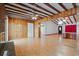Open-concept living room showcases wood-paneled walls, exposed beams, and hardwood floors at 1579 Palmetto St, Clearwater, FL 33755
