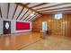 Inviting living room features exposed wood beams, hardwood floors, and wood paneling at 1579 Palmetto St, Clearwater, FL 33755