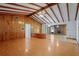Spacious living room features wood paneling, wood beams, and hardwood floors, with an open layout at 1579 Palmetto St, Clearwater, FL 33755
