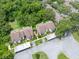 Aerial view of townhomes shows lush greenery, mature trees, and a well-maintained community at 1712 Lake Cypress Dr # 1604, Safety Harbor, FL 34695