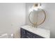 Modern bathroom vanity featuring a round mirror and brushed gold hardware at 1712 Lake Cypress Dr # 1604, Safety Harbor, FL 34695