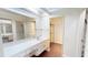 Bright bathroom with tile counters and adjacent closet and shower at 1712 Lake Cypress Dr # 1604, Safety Harbor, FL 34695