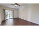 Spacious bedroom featuring hard wood floors and a screened in balcony at 1712 Lake Cypress Dr # 1604, Safety Harbor, FL 34695