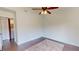 Bedroom space, hardwood flooring, ceiling fan, adjacent to laundry room at 1712 Lake Cypress Dr # 1604, Safety Harbor, FL 34695