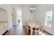 Dining room with hardwood floors next to kitchen, under ornate chandelier at 1712 Lake Cypress Dr # 1604, Safety Harbor, FL 34695
