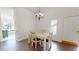 Dining room with table and chairs, lit by chandelier, with door to outside at 1712 Lake Cypress Dr # 1604, Safety Harbor, FL 34695