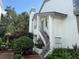 Charming two-story home with landscaped yard, staircase to the door, and lush greenery at 1712 Lake Cypress Dr # 1604, Safety Harbor, FL 34695