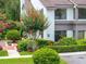 Charming townhouse exterior with lush landscaping, including a flowering tree at 1712 Lake Cypress Dr # 1604, Safety Harbor, FL 34695