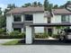 Well-maintained two-story home with a covered parking area, manicured landscaping, and a welcoming entrance at 1712 Lake Cypress Dr # 1604, Safety Harbor, FL 34695