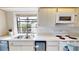 Modern kitchen with white countertops, stainless steel sink, and appliances at 1712 Lake Cypress Dr # 1604, Safety Harbor, FL 34695