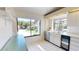 Bright kitchen area with white cabinets, stainless steel appliances, and large windows at 1712 Lake Cypress Dr # 1604, Safety Harbor, FL 34695