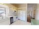 Bright kitchen featuring white appliances, ample cabinet space, and a large window for natural light at 1712 Lake Cypress Dr # 1604, Safety Harbor, FL 34695